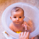 What is the ideal water temperature for bathing the baby?